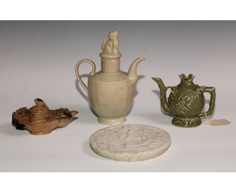 A Chinese celadon melon-shaped libation pot, crackle glaze, the cover crested by a Dog of Fo finial, scroll spout and handle,