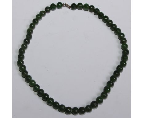 A Chinese jade bead necklace, 40cm long 