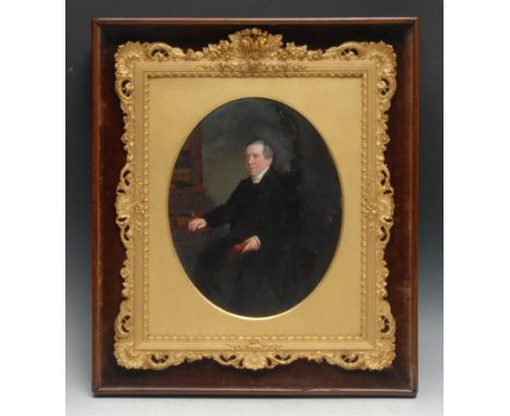 A 19th century portrait, of a gentleman in his library, oval, oil on photograph, oval, 24cm x 19cm, rosewood case frame with 