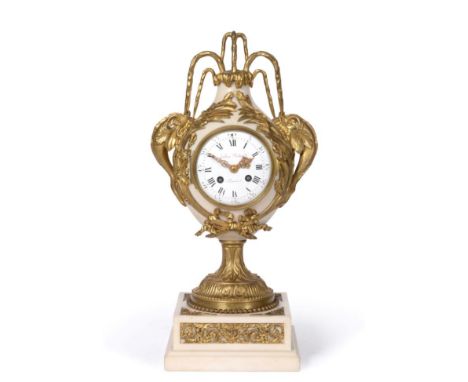 A French Alabaster and Gilt Metal Mounted Striking Mantel Clock, early 20th century, urn shaped case surmounted by dolphins s