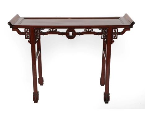 A Chinese Hardwood Altar Table, late 19th/early 20th century, of rectangular form with scrolled ends above a decorative friez