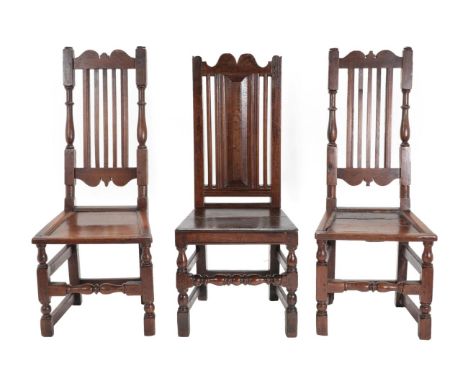 A Pair of Joined Oak Back Stools, English or Welsh, circa 1700, with slatted back supports and turned uprights above moulded 