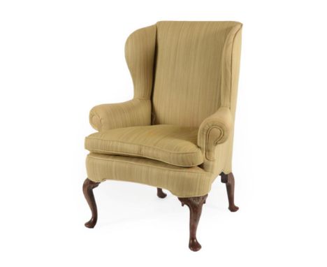 A George III Mahogany Framed Wing-Back Armchair, late 18th century, recovered in green fabric, with rounded arm supports abov