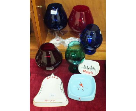 Three Wade PM advertising ashtrays, coloured glass brandy glasses, etc.