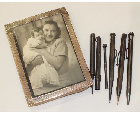 A rectangular engine-turned silver photograph frame, 15 x 11cm, Birmingham 1948, (a/f), two sterling silver propelling pencil