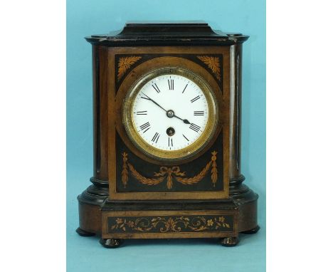 A 19th century walnut and mahogany mantel clock with circular enamelled dial and drum movement, 27cm high.