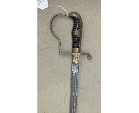 A German dress sabre, the brass frame embossed with oak leaves, wire-bound black grip and single-fullered 88cm blade, (no sca