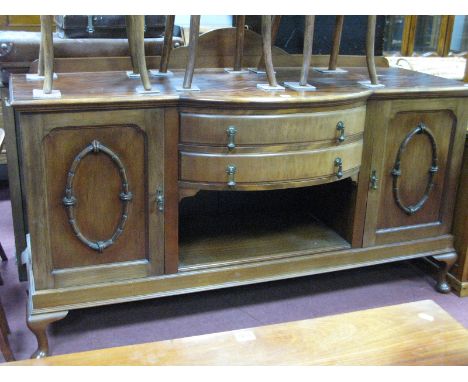 A 1920's Mahogany Bow Fronted Sideboard, with low back, end cupboards, flanking twin drawers over open shelf on squat cabriol