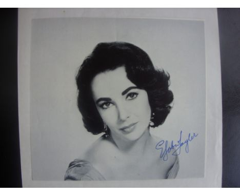Elizabeth Taylor Signed Magazine Photo: Neatly signed undedicated which is roughly 8 x 8 inches. Nice item.