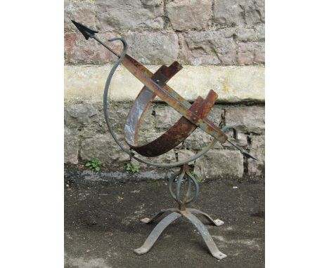 A weathered light steel garden armillary sundial 