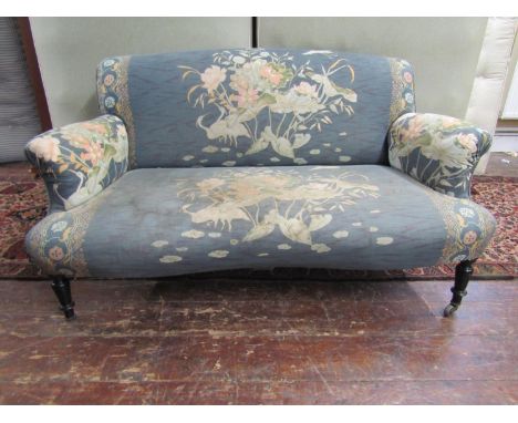 An Edwardian two seat sofa, with later upholstered finish, on turned and ebonised supports, 145cm wide 