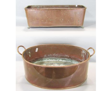 A 19th century copper oblong window planter with lion mask rings on paw feet 46cm wide, and an oval copper planter, 34cm wide