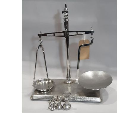 A vintage polished beam balance scale and weights 