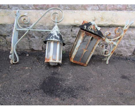 A vintage iron work wall mounted exterior lantern of octagonal form with conical roof and scroll work bracket, together with 