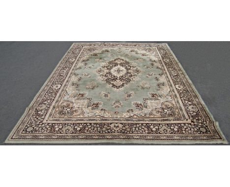 A House of Fraser 'Kasmir' carpet (see label) in a Persian design, pale green ground (af stained) 340cm x 250cm 