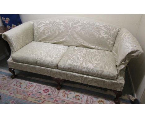 A good quality Georgian style three seat sofa with arched back and scrolled arms, raised on carved mahogany claw and ball sup