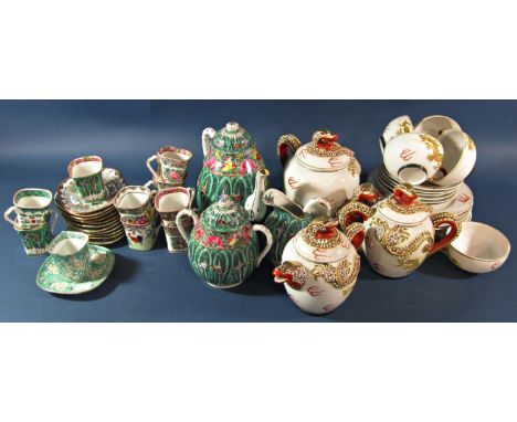 A Japanese porcelain tea service in the European style with acanthus scrolling detail, together with four gold plated Jumbo s