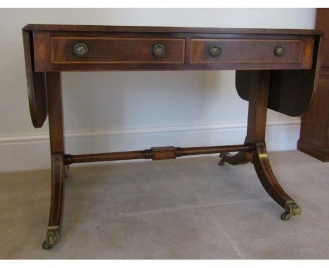 A good quality traditional Georgian style sofa table by Brights of Nettlebed, with two real and two dummy drawers, drop leave