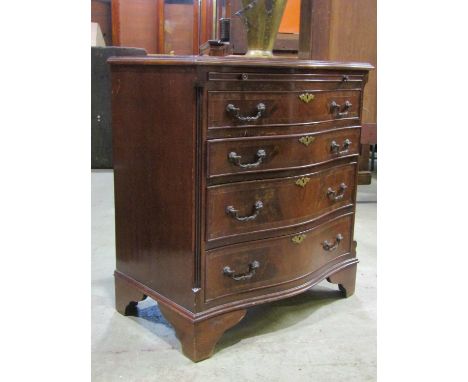 A reproduction Georgian style Batchelors chest with serpentine front enclosing four long graduated drawers beneath a brushing