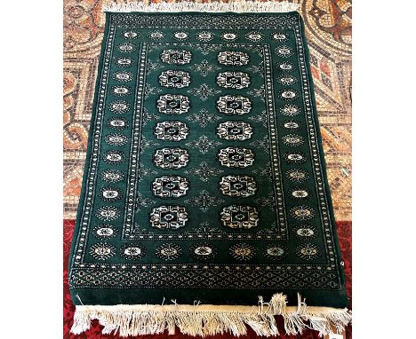 An unusual green Turkoman rug with a central panel of elephant foot gul, 110cm x 80cm approx. 