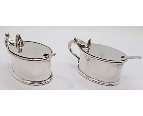 Pair of 19th century gold plated lunettes and two silver plated mustard pots of oval form, both with blue glass liners, toget