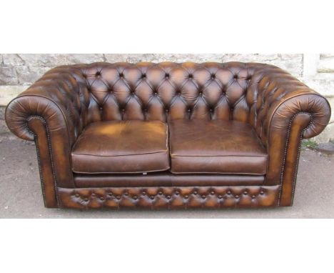 A Thomas Lloyd traditional two seat chesterfield sofa with loose seat cushions (af) 