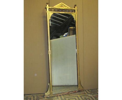 An aesthetic movement gilt framed pier mirror with chamfered and simple incised detail beneath a turned gallery and architect