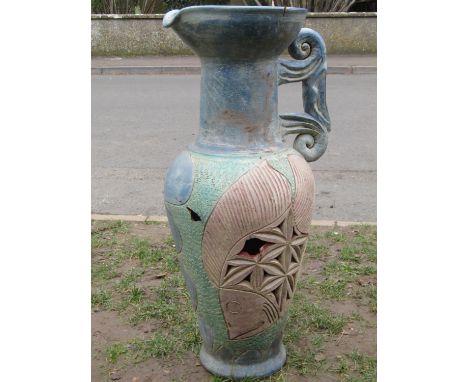 A large contemporary painted and incised terracotta pitcher with fan tailed fish, scrolled handle and further detail (af), 85