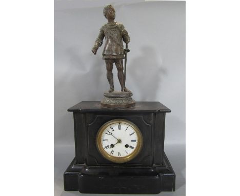 A Victorian black slate mantle clock with eight day striking movement, surmounted by a spelter figure male character in milit