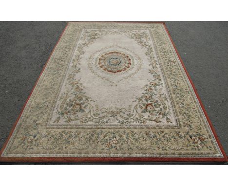 A machine made carpet of European design with a floral central and trailing flowers on a cream ground, 280cm x 200cm 