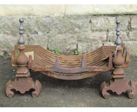 A cast iron fire grate and loose dogs with brass finials and scrolled supports, together with a further pair of fire dogs wit