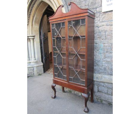 A Georgian mahogany side cabinet with broken swan neck architectural pediment over a pair of three quarter length astragal gl