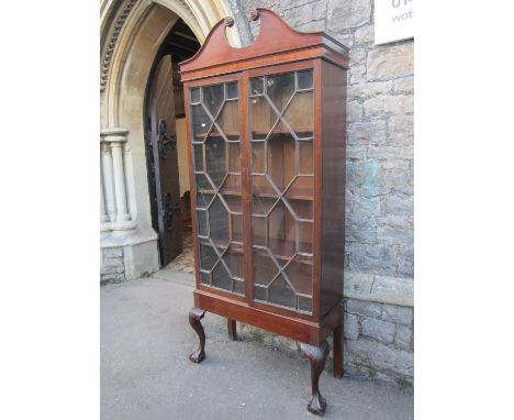 A Georgian mahogany side cabinet with broken swan neck architectural pediment over a pair of three quarter length astragal gl