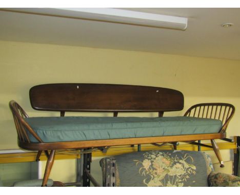 An Ercol day bed in mid-brown colour, with detachable elm back on turned supports (for restoration) 