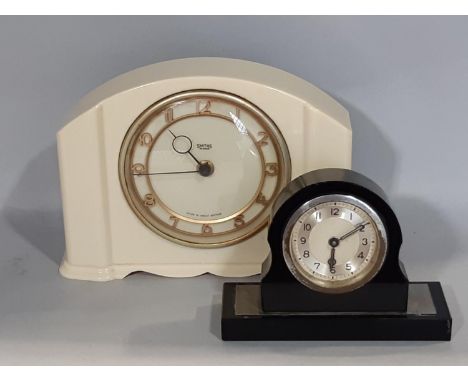 An art deco bedside clock with eight day time piece, together with one other by Smith's in a white plastic case 