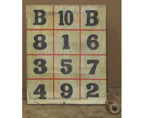 A vintage quoits game with numbered canvas stretcher, together with five rings 