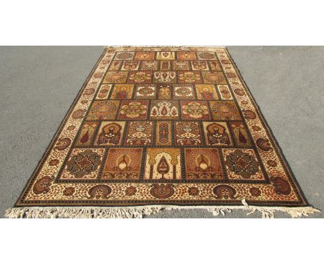 A machine made 'Super Kashan' carpet with panels of peacocks and flowers in gold and amber tones, 295cm x 200cm approx 