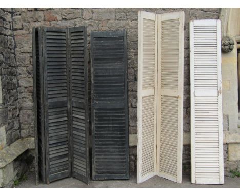 Two similar vintage stained pine four fold shutters, 43 and 33 cm (each panel width), together with a further pair of two fol