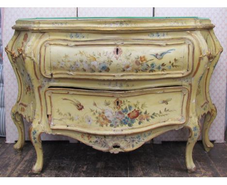 A 19th century Italian pine bombe shaped commode, the shaped outline enclosing two graduated frieze drawers with applied and 