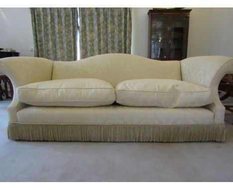 A good quality Georgian style wing sofa in a pale cream fabric, with camel back and two heavy loose cushions, 2.6m long x 110