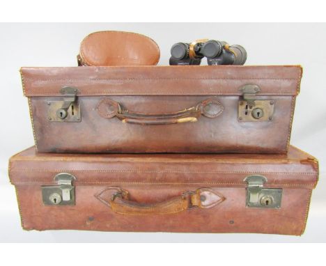 Two vintage brown leather suitcases and a pair of Rank Aldis binoculars 7 x 50 in a case, strap broken. 