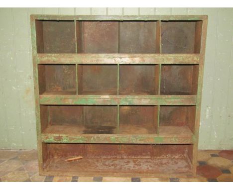 A vintage industrial segmented open shelving unit with remains of original green painted finish, 91 cm wide x 24 cm deep x 91