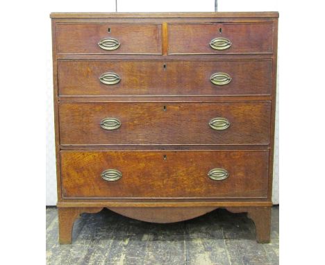 A Regency period oak countrymade chest of two long and two short drawers, with oval brass plate handles and bracket supports,
