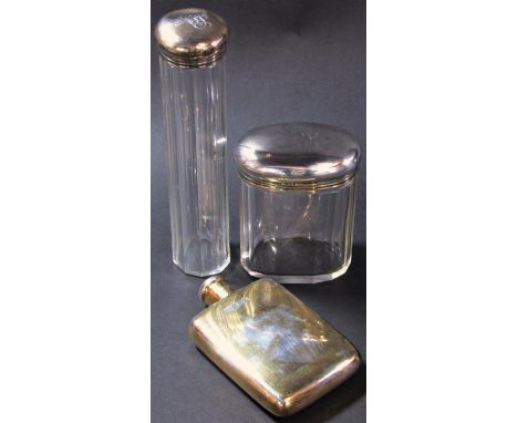 A silver hip flask, London 1909, maker John Collard Vickery, and two silver capped glass vanity bottles. 3.7 oz approx (3) 