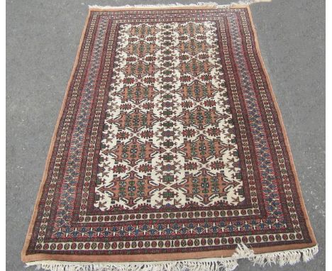 A Kazak type carpet with a busy geometric central panel, 182cm x 125cm 