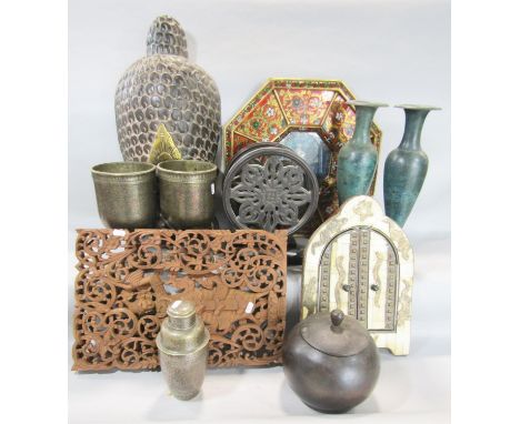 A collection on Indian tourist artefacts including a pair of large richly engraved cups a pair of lotus wheels, a pair of ver