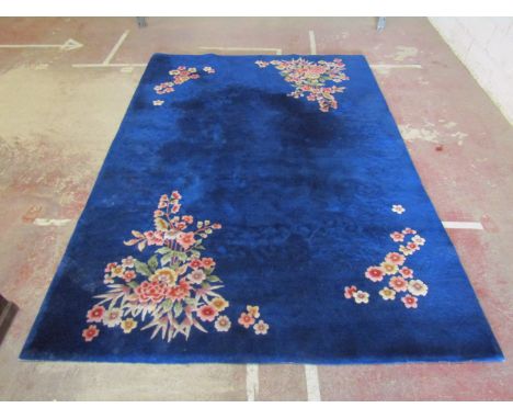 A Chinese wool carpet with pale blue ground in alternating running borders and floral detail, 360 x 260 cm approximately (AF)