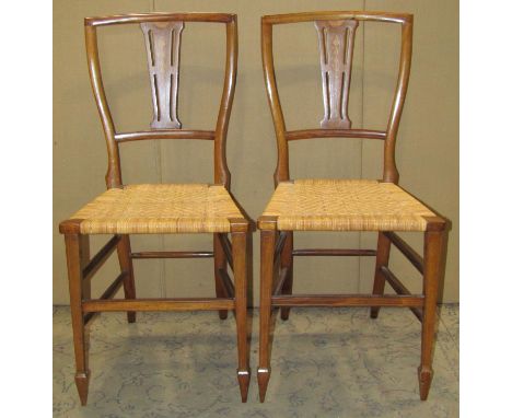 A pair of light weight inlaid Edwardian mahogany occasional or bedroom chairs with pierced splats over cane seats 