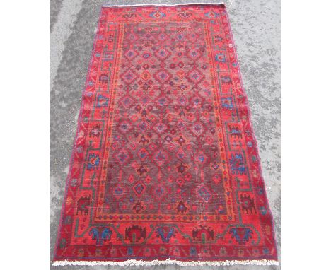 A Turkish wool carpet with diamond eye pattern on a predominantly red ground.  210cm x 115cm approx. 