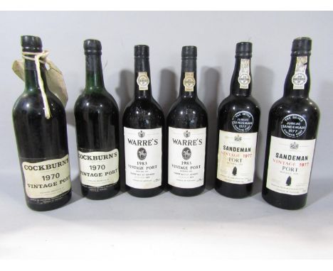 Six bottles of vintage port comprising Cockburn's 1970, two bottles of Sandeman vintage 1977, two bottles of Ware's 1983 vint